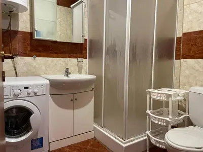 a bathroom with a toilet sink and a washing machine at Amartmán přímo u moře - Elenite in Sveti Vlas