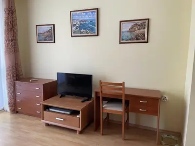 a room with a desk with a television and a chair at Amartmán přímo u moře - Elenite in Sveti Vlas
