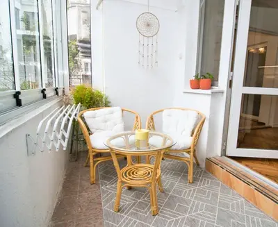 a patio with two chairs and a table on a porch at The Puzzle in Varna City