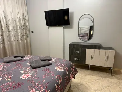 a bedroom with a bed and a mirror and a dresser at YS Platinum Residence in Sunny Beach