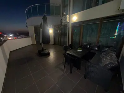 a balcony with a table and chairs on a building at YS Platinum Residence in Sunny Beach