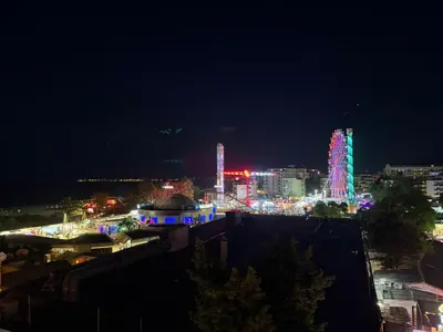 a view of a city at night with lights at YS Platinum Residence in Sunny Beach
