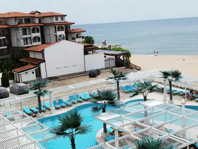 an aerial view of a resort with a pool and a beach at Апартамент в КК 
