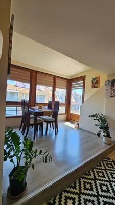 a dining room with a table and chairs at Уютно студио до центъра на Бургас in Burgas City