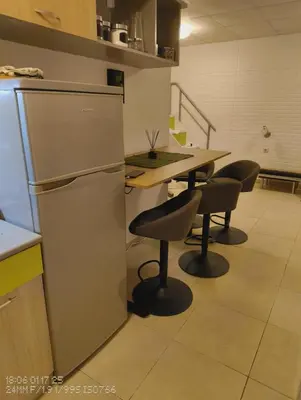 a kitchen with a table and chairs and a refrigerator at Tarsis nova slunchev Briak Apartament 08 A in Sunny Beach