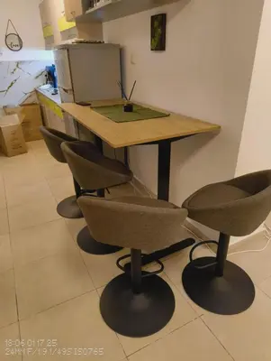 a wooden table with four chairs in a kitchen at Tarsis nova slunchev Briak Apartament 08 A in Sunny Beach