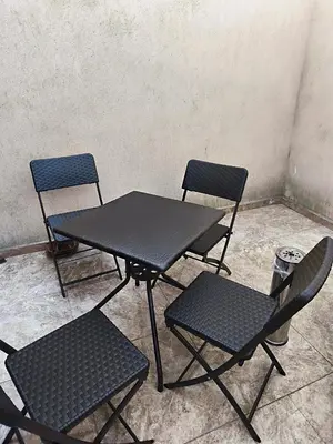 three chairs and a table and a table and chairs at Tarsis nova slunchev Briak Apartament 08 A in Sunny Beach