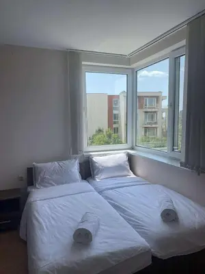 two beds in a room with two windows at Family, Friendly 2 Bed Apartment in Sunny Beach
