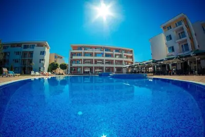 a large blue swimming pool in front of buildings at Family, Friendly 2 Bed Apartment in Sunny Beach
