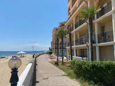 a sidewalk next to a beach with a building at ANDALUSIA BEACH A602 Elenite in Burgas City