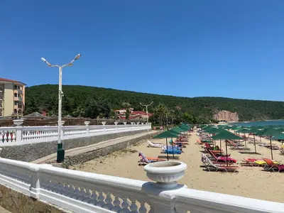 a beach with a bunch of chairs and umbrellas at ANDALUSIA BEACH A602 Elenite in Burgas City