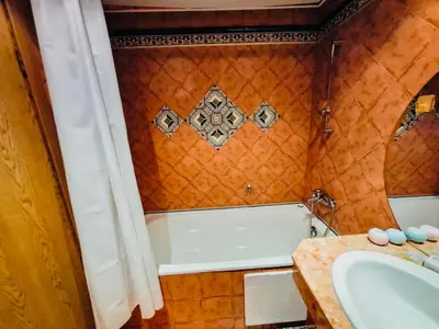 a bathroom with a bath tub and a sink at ANDALUSIA BEACH A602 Elenite in Burgas City