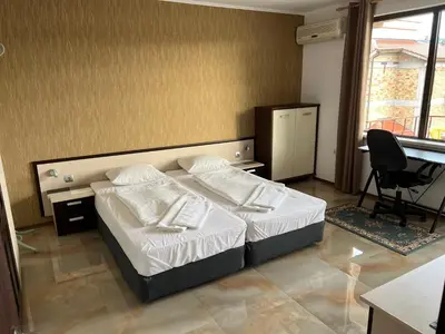 a bedroom with a bed and a desk and a chair at Apart di Landi in Ravda