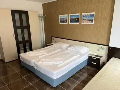a bedroom with a large bed with white sheets at Apart di Landi in Ravda