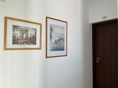 three pictures are hanging on a white wall at Apart di Landi in Ravda