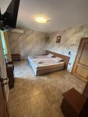 a bedroom with a bed in a room at Стая за гости - 1 in Sozopol