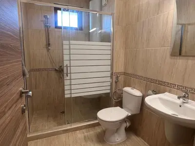 a bathroom with a shower and a toilet and a sink at Deluxe Apartment with Sea View Vineyard Spa Resort Aheloy in Aheloy