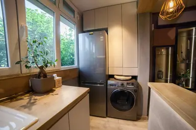 a kitchen with a stainless steel refrigerator and a dishwasher at KIM Centre in Burgas City