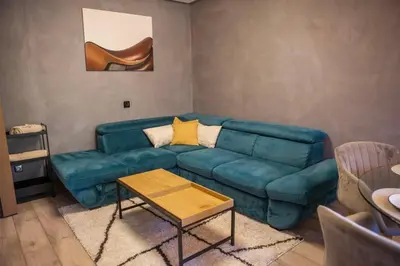 a living room with a blue couch and a table at KIM Centre in Burgas City