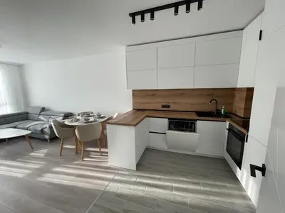 a kitchen and living room with a table and a couch at Сарафово in Burgas City