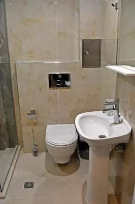 a bathroom with a toilet and a sink at Anvers Apartments in Sozopol
