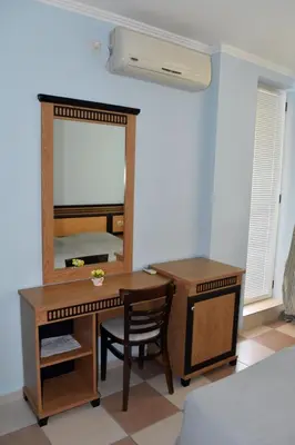 a bedroom with a desk and a mirror and a bed at Anvers Apartments in Sozopol