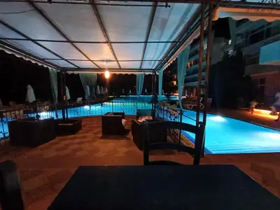 a view of a swimming pool at night at Penthouse Studio Apartment in Sunny Beach