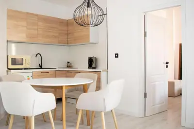 a kitchen and dining room with a table and chairs at Hotel Grenada in Sunny Beach