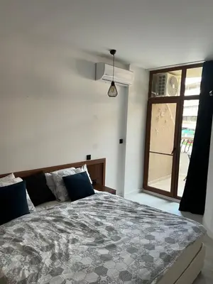 a bedroom with a large bed and a window at Hotel Grenada in Sunny Beach