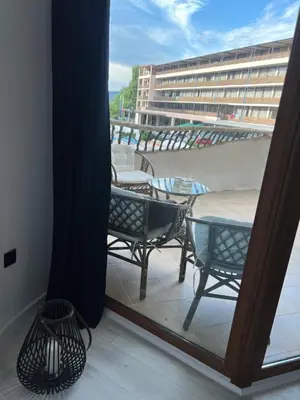 a balcony with chairs and a table and a building at Hotel Grenada in Sunny Beach