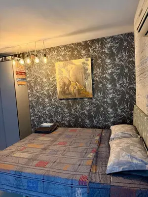 a bedroom with a bed and a painting on the wall at Art Lux Studio 1 in Burgas City