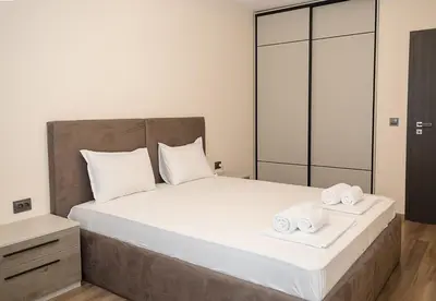 a bedroom with a bed with two towels on it at Exclusive Central Varna Apartment - 2 Beds and Parking by Flat Mаnаger in Varna City