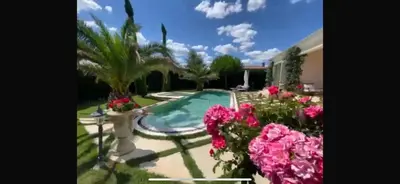 a garden with a swimming pool and flowers at Villa Dolce Vita in Sunny Beach