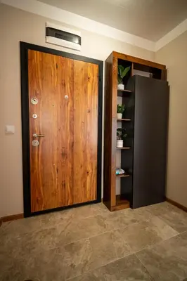 a wooden door in a room with a refrigerator at Marea Garden, Ravda - 1BD Apartment with Pool by Flat Mаnager in Ravda