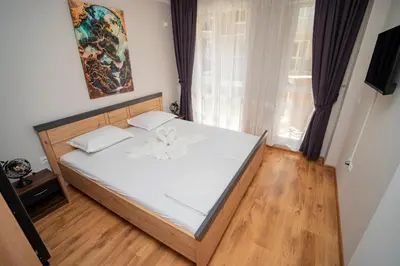 a bedroom with a bed with white sheets and a window at Marea Garden, Ravda - 1BD Apartment with Pool by Flat Mаnager in Ravda
