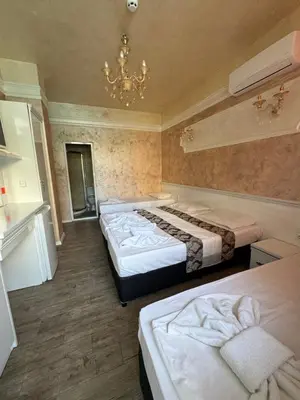 a bedroom with two beds and a chandelier at Residensia Bahami in Sunny Beach