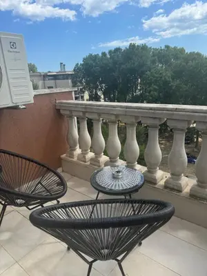 a patio with two chairs and a table on a balcony at Residensia Bahami in Sunny Beach
