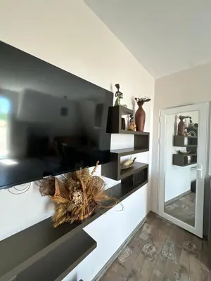 a living room with black and white shelves at Residensia Bahami in Sunny Beach