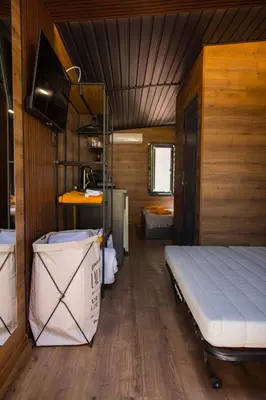 a bedroom with a bed in a small room at Къмпинг- бунгала Албатрос in Varna City