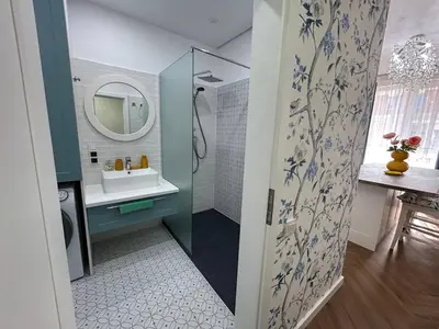 a bathroom with a shower and a sink and a mirror at Bayview Family 2 in Burgas City