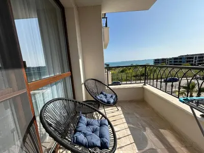 two chairs on a balcony with a view of the ocean at Bayview Family 2 in Burgas City