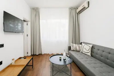 a living room with a couch and a table at Hotel Sozopol 99 in Sozopol