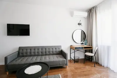 a living room with a couch and a table at Hotel Sozopol 99 in Sozopol