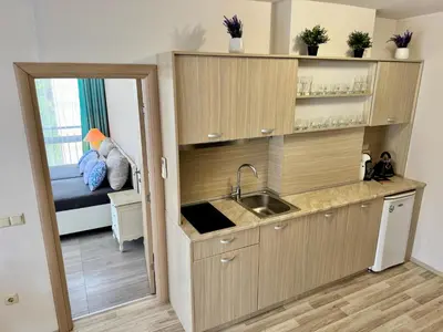 a kitchen with a sink and a room with a bed at Apartment B48 in Tarsis Club Complex in Sunny Beach