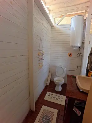 a bathroom with a toilet and a sink at Яката Каравана in Kiten
