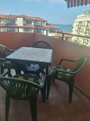 a table and two chairs on a balcony at Beachfront Studio with Sea Views in Sveti Vlas