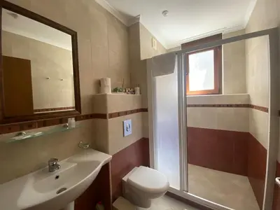 a bathroom with a toilet and a sink and a shower at Summer Mood, Forest Feeling in Sozopol in Sozopol