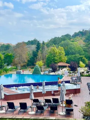 a man standing next to a swimming pool at Apartment at the Seaside in Sozopol