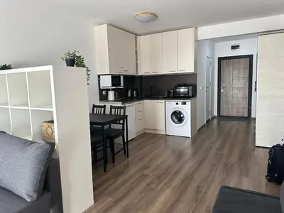 a kitchen and living room with a table and a dining room at Relaxing studio in Shartrez in Shkorpilovtsi