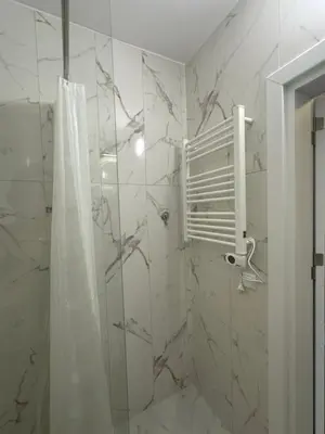 a bathroom with a shower with a shower curtain at Relaxing studio in Shartrez in Shkorpilovtsi